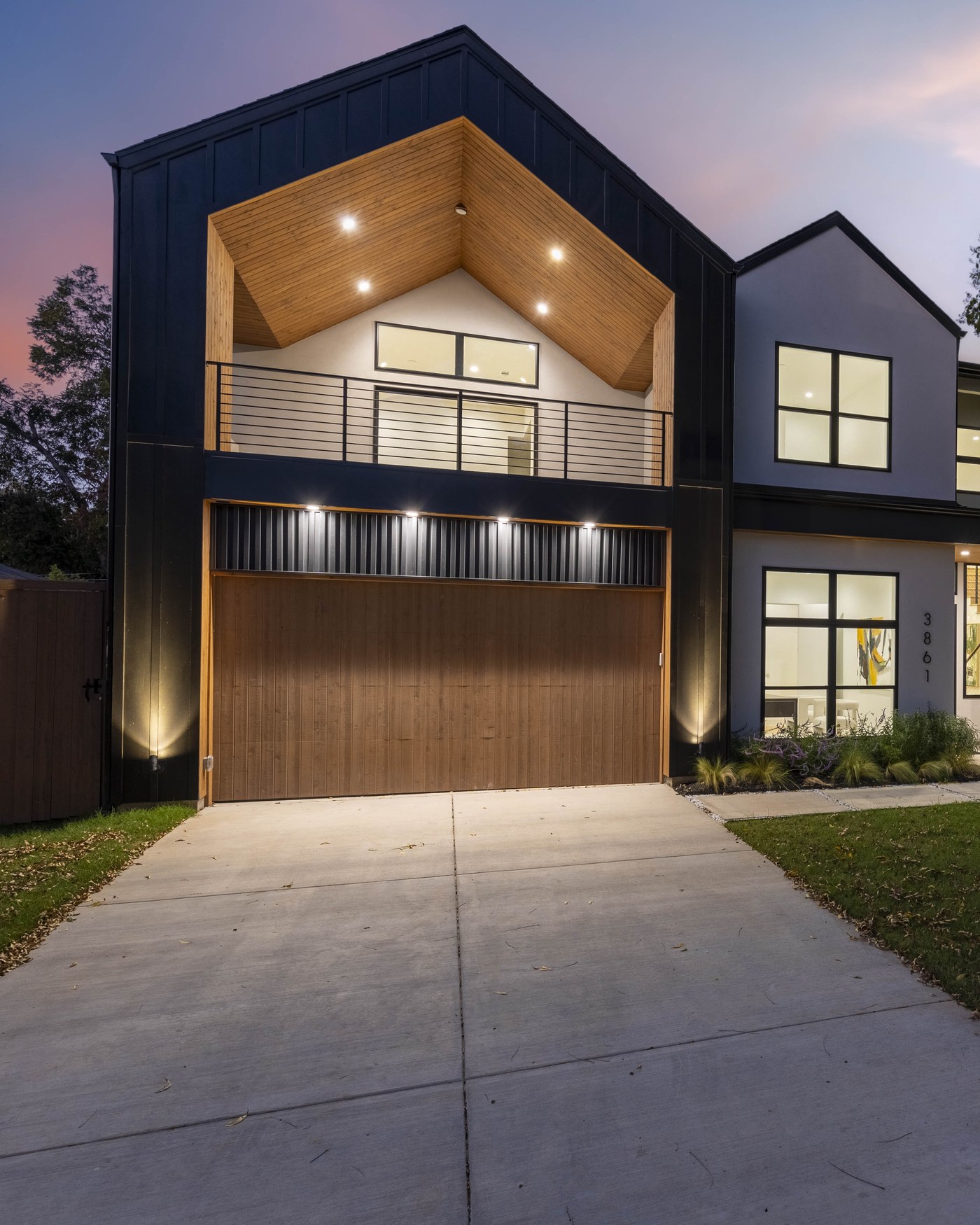 A modern DFW home co-hosted by Dreamland Stays, lit up at dusk
